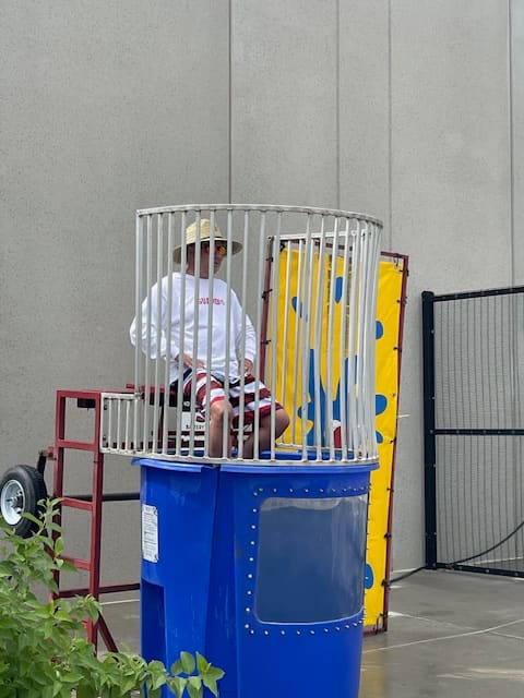Dunk tank at a summer company cookout — good-natured fun and friendly competition